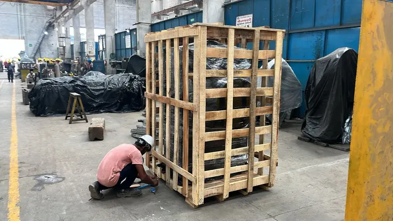 Crate being built around a machine at a customer's factory