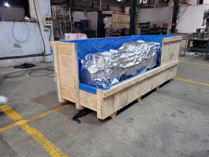 Machine vacuum-sealed in silver foil inside a crate lined with blue VCI sheet